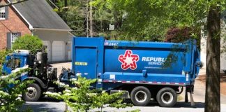 A Republic Services truck picks up residential garbage on a Coventry subdivision street earlier this year. Photo/Cal Beverly.