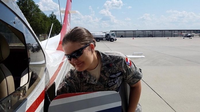 Cadet Chief Master Sergeant Dawn Patrick gathers her belongings after completing an airborne photographic mission in the aftermath of Hurricane Dorian. Photo/Civil Air Patrol mission pilot Lt. Col. Larry Taylor.