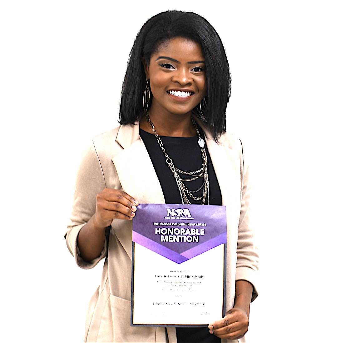 <b>Nia Washington, public information specialist, proudly displays her award for social media from the National School Public Relations Association. Photo/Fayette County School System.</b>