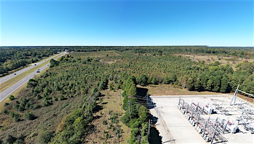 <b>Another view of the Lester property looking southwest across a power substation just off Veterans Parkway town with Hwy. 54 (at left) headed toward Peachtree City. Photo/FCDA.</b>