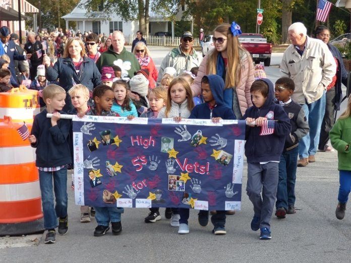 The students at Liberty Tech Charter School in Brooks made sure Veterans Day was a special event by holding a parade and live music downtown. Photo/Ben Nelms.