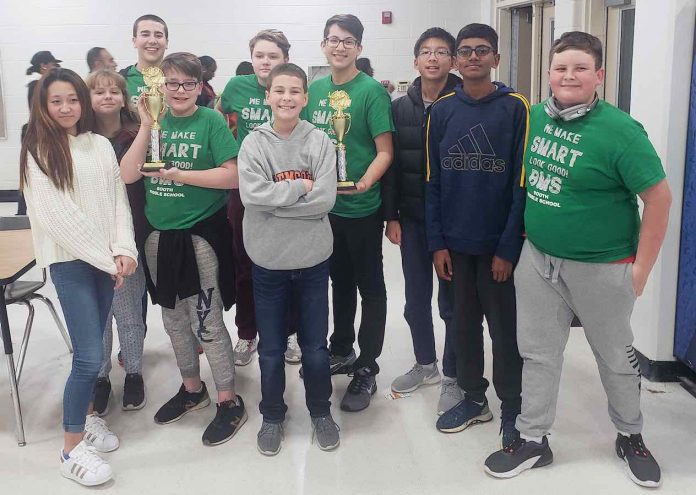 The academic team at J.C. Booth Middle show off their trophies after winning the Middle School Academic Bowl with an undefeated season. Photo/Fayette County School System.