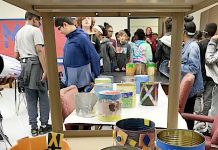 Empty aluminum food cans saved from the trash and turned into planters are ready for soil and plants. Photo/Fayette County School System.