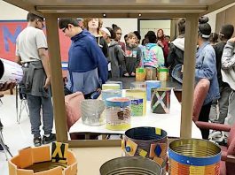 Empty aluminum food cans saved from the trash and turned into planters are ready for soil and plants. Photo/Fayette County School System.