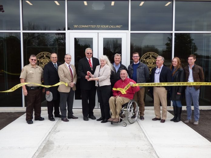 Present for the Dec. 12 ribbon cutting at the new Fayette County Sheriff’s Office Shooting Range and Training Center on Hewell Road were, from left, Capt. Troy McCollum, Fayetteville Councilman Paul Oddo, Fayette County Commissioner Chuck Oddo, Fayette County Commission Chairman Randy Ognio, Maj. Michelle Walker, Fayette County Administrator Steve Rapson, Fayette County Commissioner Eric Maxwell, Project Manager Tim Symonds, K.A. Oldham Design representatives Kip Oldman and Lynda Alexander and Oak Construction representative Hampton Vann. Photo/Ben Nelms.