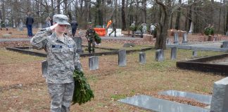 Civil Air Patrol Cadet and Peachtree City resident Skyla Ziegler salutes after placing a wreath at the gravesite of a veteran in the Fayetteville Cemetery at the Wreaths across America observance on Dec. 14. Photo/Ben Nelms.