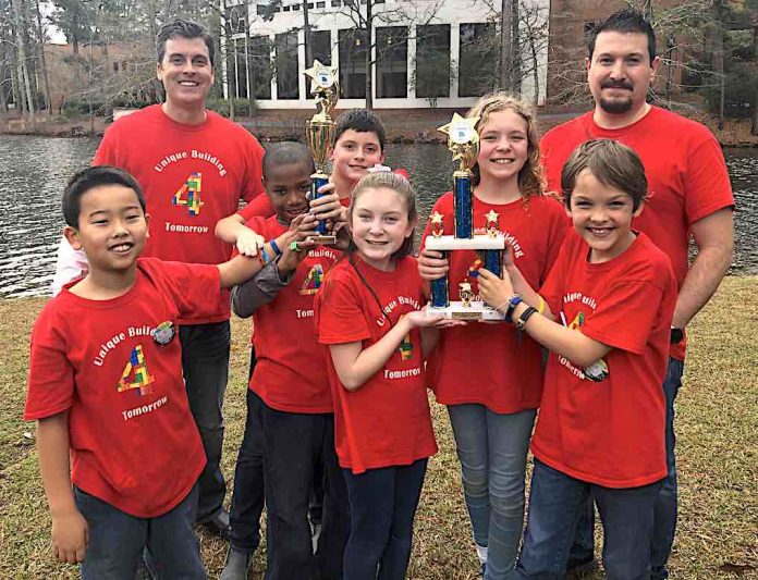 Crabapple Lane Elementary won the grand championship at the FIRST LEGO League Super Regional competition and are heading to the state competition in February. Team members (L-R) Masaya Misugi, Thomas Morrow, Corin Staples, Isabelle Sanchez, Ember Vlachos , and Mark Blahnik. Coaches are Patrick Staples and Jaime Sanchez. Photo/Fayette County School System.