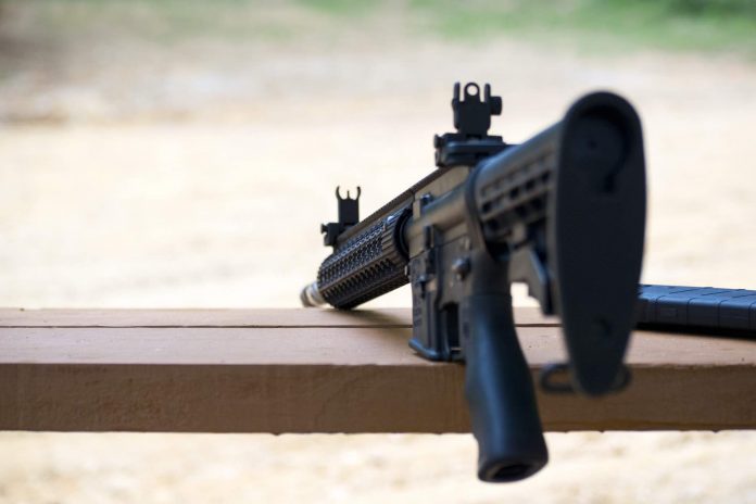 An AR-15 semi-automatic rifle on a bench rest. Shutterstock photo.