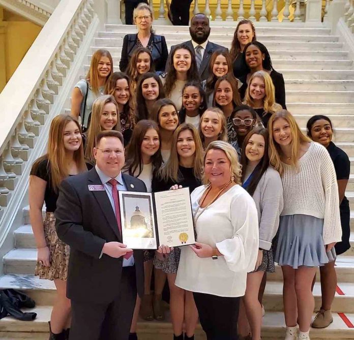 McIntosh High School cheer squad and coaches receive the House resolution from Peachtree City Rep. Josh Bonner (front left). Photo/Submitted.
