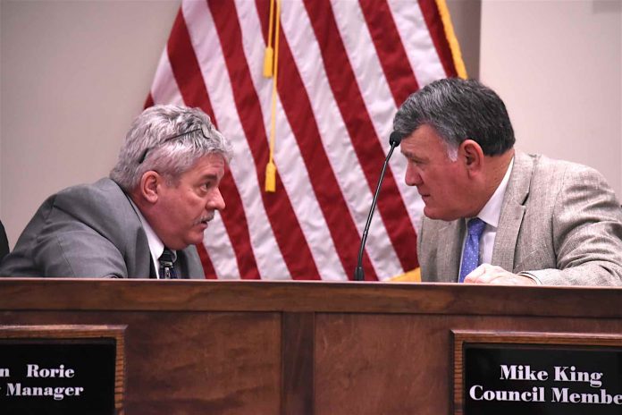 Peachtree City Manager Jon Rorie (L) and City Councilman Mike King have a chat before the meeting gets underway March 5. Photo/Cal Beverly.