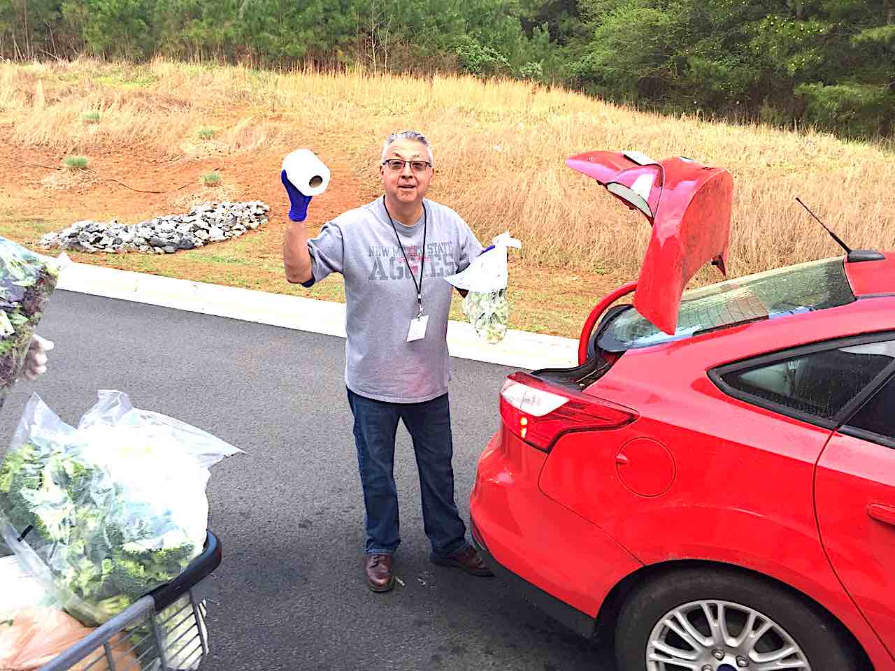 <b>Real LIfe Center volunteer George Holguin hoists a familiar household item to show part of what goes into helping families. Photo/Real LIfe Center.</b>