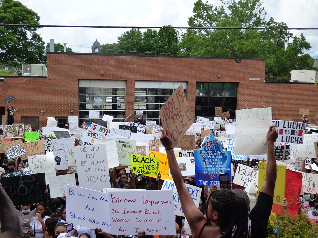 A group of approximately 2,000 held a protest in Fayetteville on June 6 over the loss of black lives to law enforcement. The protest began at the Fayette Pavilion and ended at City Hall (fire station in background). Photo/Ben Nelms.