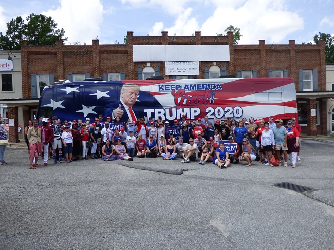 <b>A portion of the 300 people attending the All-American Rally for Trump on Aug. 1 in Fayetteville took time out with the Trump bus at the Fayette County GOP Event Center. Photo/Ben Nelms.</b>