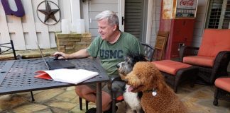 Testing positive for Covid-19 has not stopped Fayette County Administrator Steve Rapson from doing his job. Rapson continued working from home on Tuesday during quarantine, with the help of his two rescue dogs. Photo/Kristi Rapson.