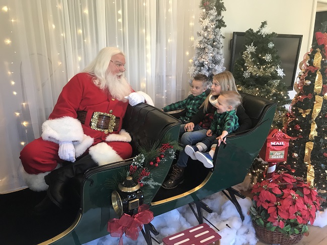 Fayetteville residents Parker Bryan, 5, (at left), Ali Bryan, 9, and J.T. Bryan, 2, were at Trilith in Fayetteville on Dec. 5 to spend time with Santa. Photo/Ben Nelms.