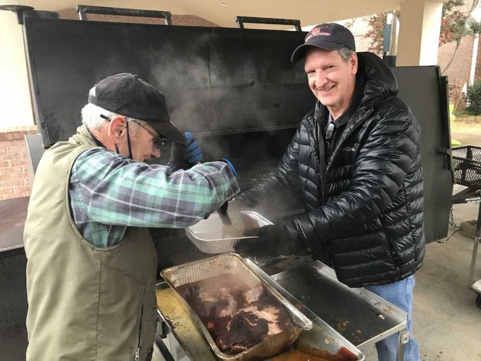 Pit masters Joe Williams and Dr. Bryan Woods hard at work. Photo/Submitted.