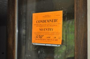 <b>Condemned sign on front of residence after cruelty to animals arrest April 8. Photo/Submitted.</b>