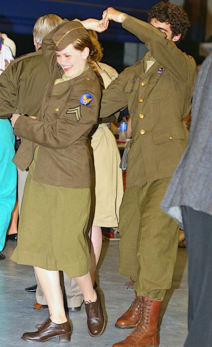 WWII Reenactors from a previous Hangar Dance enjoy the swing music and 1940s atmosphere of CAF Airbase Georgia's annual event, which returns Sept. 25 at Falcon Field in Peachtree City. The dance honors the memory of the Greatest Generation and supports Airbase Georgia's aircraft restoration programs. Photo/Pam Ellis.