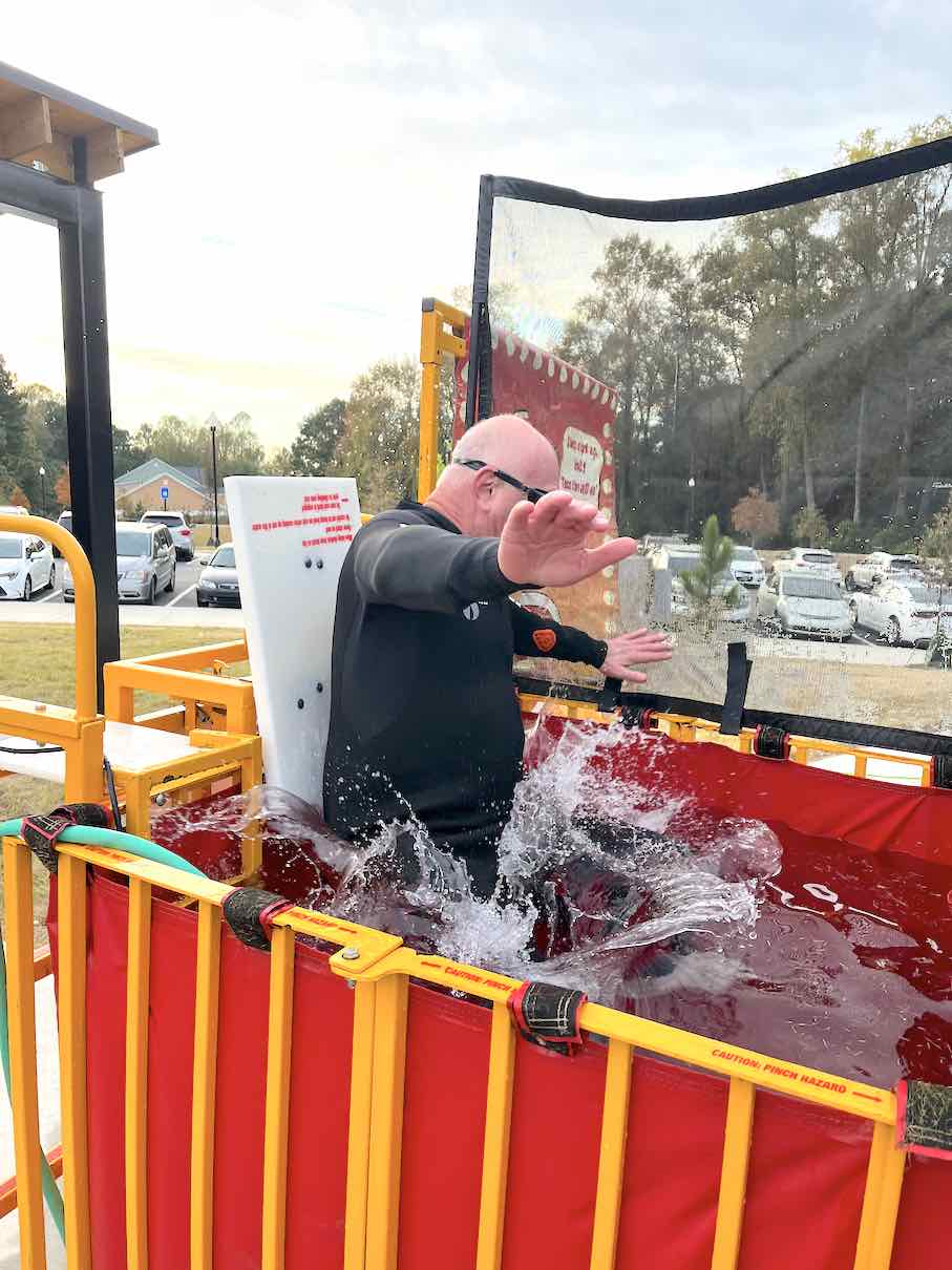 Who says an Air Force vet can’t deal with a little water? Fayetteville Councilman Scott Stacy now holds the unofficial city record for being dunked 20 times on Nov. 6 at the Carnival in the Park event. And, as usual, and wetsuit notwithstanding, the comically-inclined councilman was all in for making a splash, actually many of them, and making sure the kids trying to dunk him had a good time. Photo/Ben Nelms.