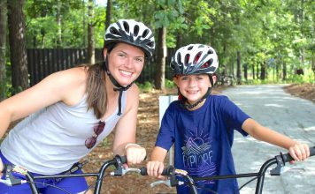 Maddie Burke and campers learn to ride bikes on the camp's brand new bike and pump track.