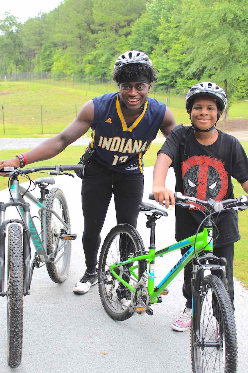 Evan Akinyemi is a Peachtree City native. Here's he's helping a new camper get started.