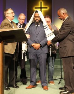 Dr. Randy Wood and men of the church pray for their new pastor, James Oney.