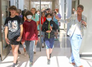Principal Deb Troutman leads current and future Booth Middle School into their new school during a tour last week. Photo/Fayette County School System.