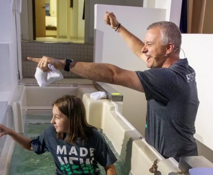 Pastor Josh Saefkow baptizes Riley Wood at Fayetteville's Flat Creek Baptist Church in August. Saefkow is being nominated for president of the Georgia Baptist Convention. [Photo/Pam Hall]