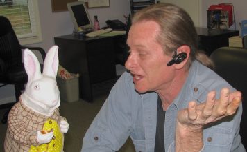 The Citizen's Ben Nelms in conversation with his ubiquitous White Rabbit, which was known to have accompanied him several times as he covered local events and government meetings.