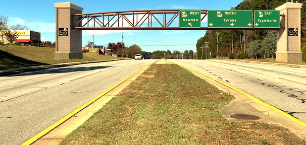A potential bridge design is superimposed on a view of Ga. Highway 74 North looking northward toward the Hwy. 54-74 intersection.