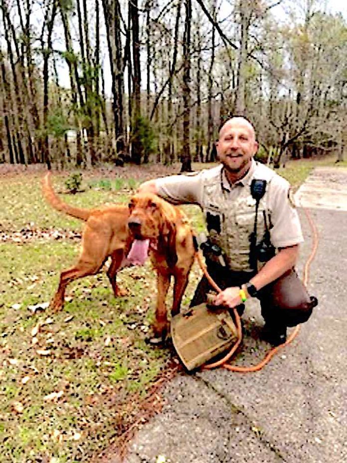 K9 Bloodhound Rufus gets congratulations from Fayette Sheriff's Deputy Lt. S. Whitlock. Photo/Fayette Sheriff's Office Facebook page.