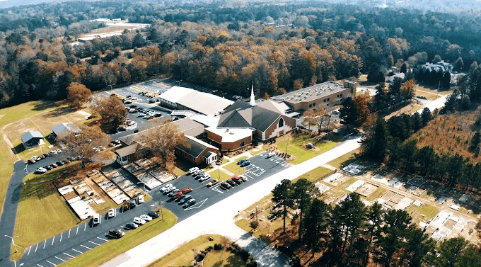 Aerial view of past of the 20-acre campus of Flat Creek Baptist Church just north of Peachtree City. The car show and crafts show will be on the rear parking lot, out of sight of Flat Creek Trail that runs in front of the church building. The church recently held a dinner on the grounds, an outdoor event that served nearly 2,000 people.