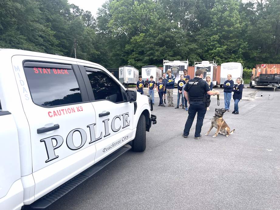 K9 Midas and his partner Cpl. Pendleton demonstrate for students. Photo/Peachtree City Police Facebook page.
