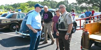 Pastor Josh Saefkow talks with Fayette County Sheriff Barry Babb during the church's car and craft show June3 art the church on Flat Creek Trail. Photo/Roger Alford.
