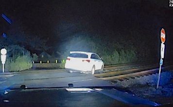 Police dash cam photo of a car parked on railroad tracks. Photo/Peachtree City Police Department.