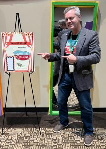The author promoting his business Country Fried Creative with signage at the 2024 Coweta Nonprofit Summit. Photo/Joe Domaleski