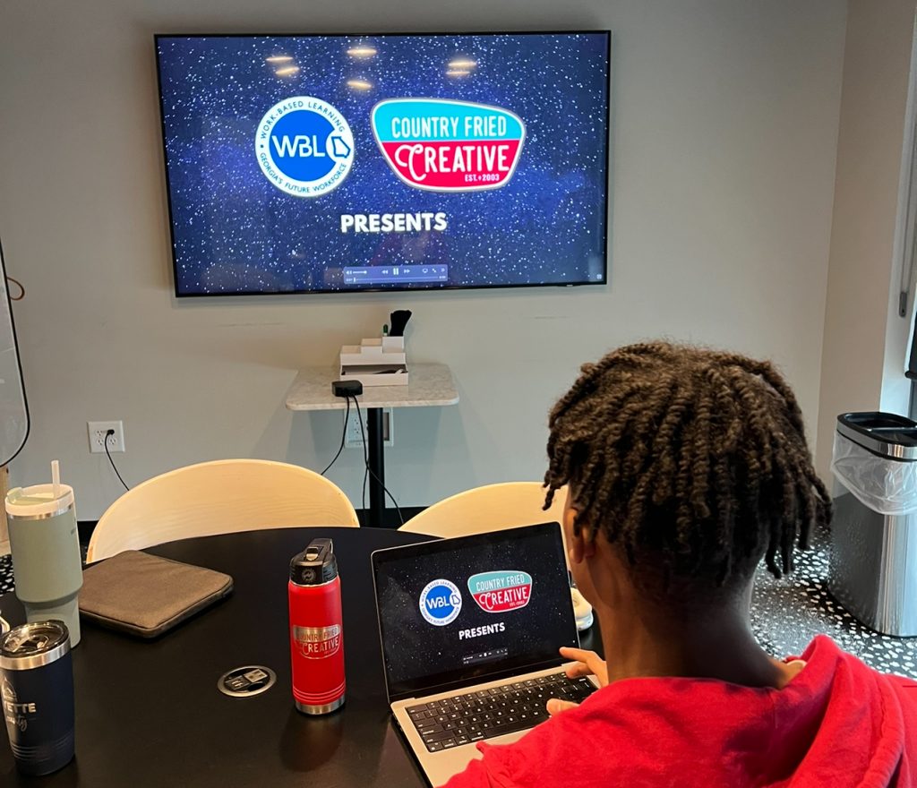 Intern Zavion Green, a senior at Sandy Creek HS, works on a promotional video for the Fayette Schools Work-based Learning program and Country Fried Creative. Photo/Joe Domaleski