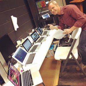 The author keeping all of the computers going at the 2017 Fayette Woman Live conference. Photo/Cal Beverly