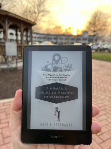 Reading the Kindle version of A Human’s Guide to Machine Intelligence by Dr. Kartik Hosanagar. Sunset in downtown Fayetteville, GA. Photo/Joe Domaleski