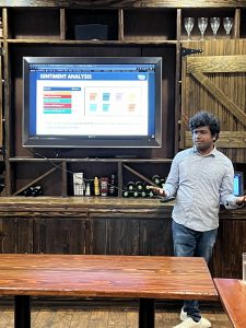 Vinay Revanuru, data science intern for CFC, presents his sentiment analysis findings at Maguire's Irish Pub on 7/24/24. Photo/Christina Colantonio