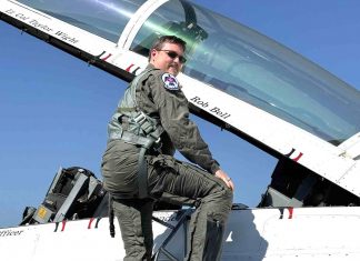 Fayette’s 2024 Teacher of the Year Rob Bell climbs into the cockpit bearing his name. Photo/Fayette County School System.