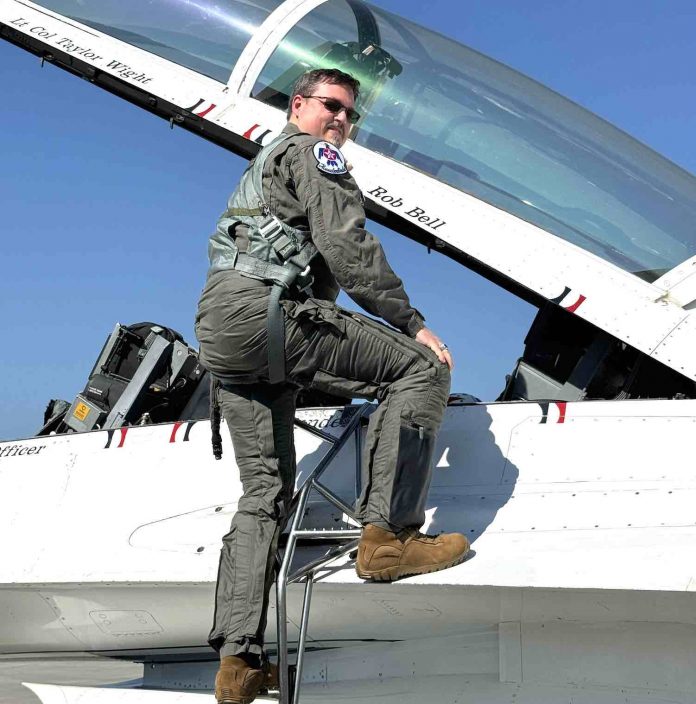 Fayette’s 2024 Teacher of the Year Rob Bell climbs into the cockpit bearing his name. Photo/Fayette County School System.