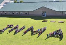 In a file photo from 2015, students line up to spell out the name of their school in Inman, south of Fayetteville.