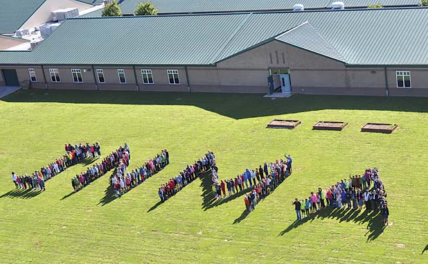 In a file photo from 2015, students line up to spell out the name of their school in Inman, south of Fayetteville.